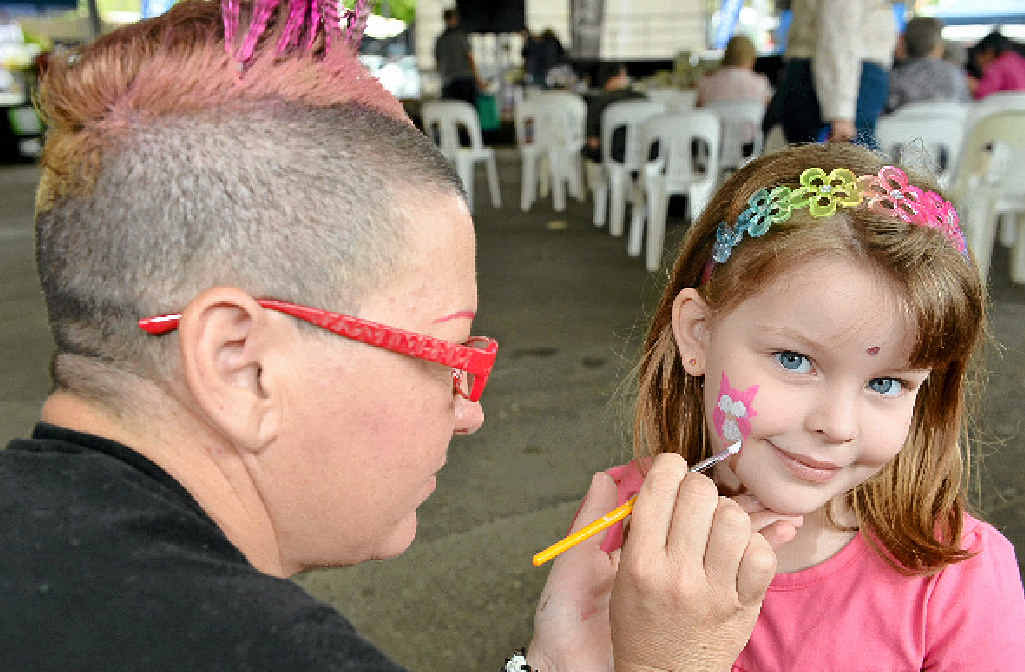 Face painter Erence McGovern gives Amber Wretham, 6, a new look. Face painter Erence McGovern gives Amber Wretham, 6, a new look.